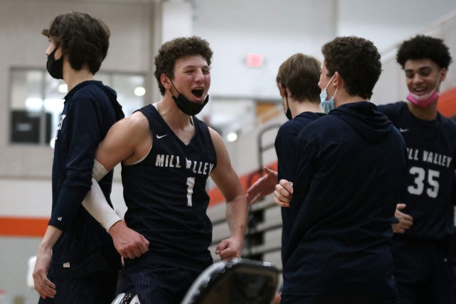 To celebrate being sub-state champions, senior Nick Mason shouts to sophomore Luke Shideler after winning against Bonner Springs 64-45. 