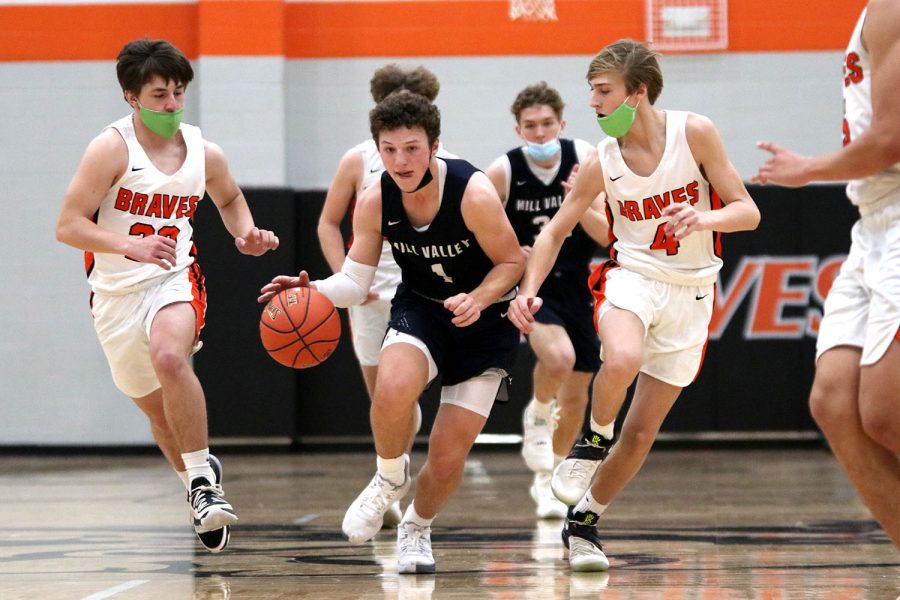 Looking down the court, senior Nick Mason sprints towards the basket while dribbling the ball Saturday, March 6. 