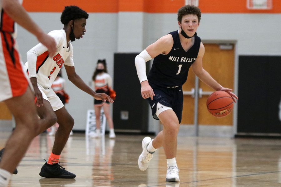 Looking at sophomore Dylan Blazer, senior Nick Mason dribbles the ball towards him before handing it off to him. 