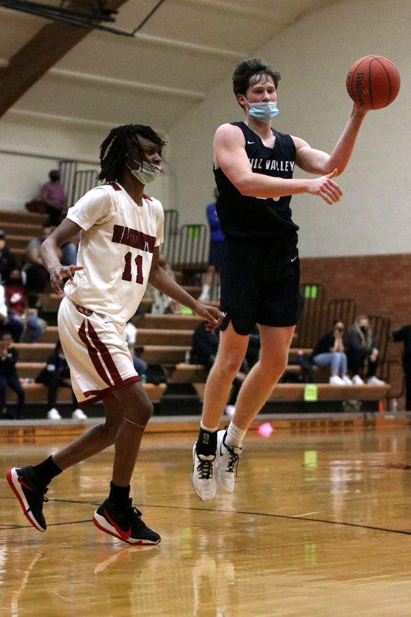 Sophomore Dylan Blazer jumps up into the air to pass the ball to an open teammate. 