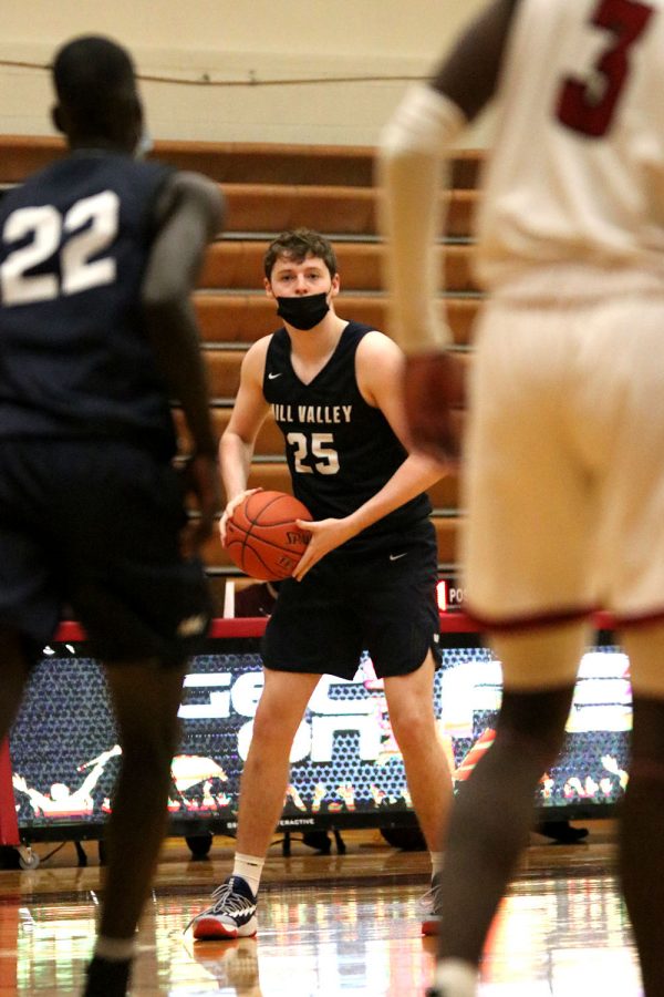 With the ball in his hands, senior Aaron Kephart looks for an open teammate to pass the ball to.