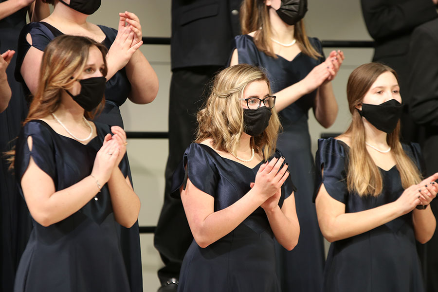 Clapping along with the song, junior Gracie Martin and the girls around her add to the singing of the song. 