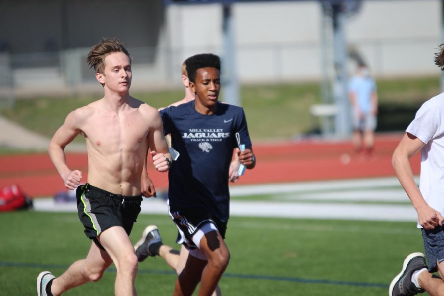 Side by side, senior Carsyn Turpin and freshman AJ Vega run several laps together around the track.