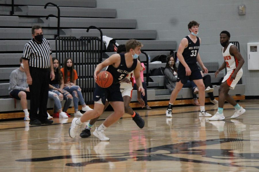 After intercepting the ball, junior jaxton vandyke tries to get around opposing defense.