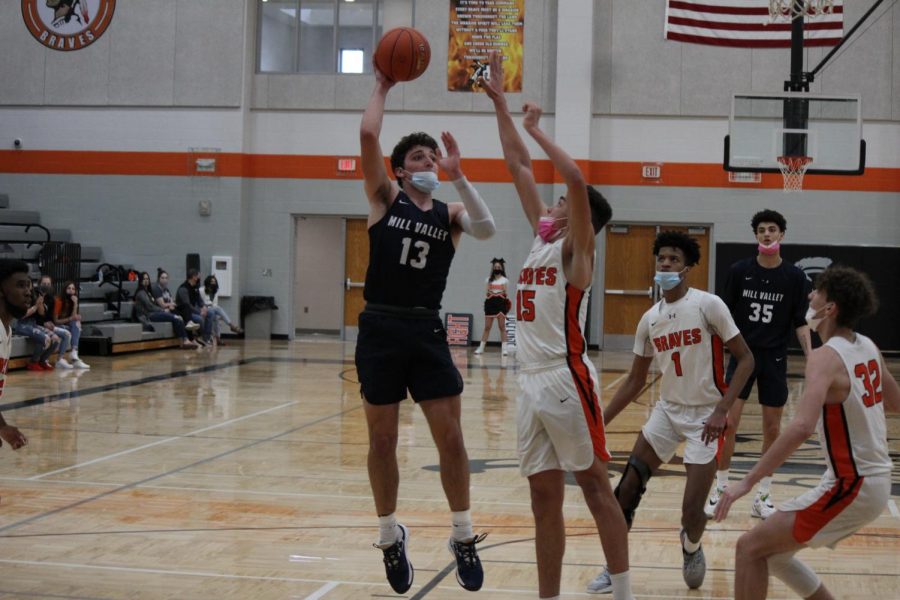 Going for a quick goal, senior peter janssen shoots around the other team.