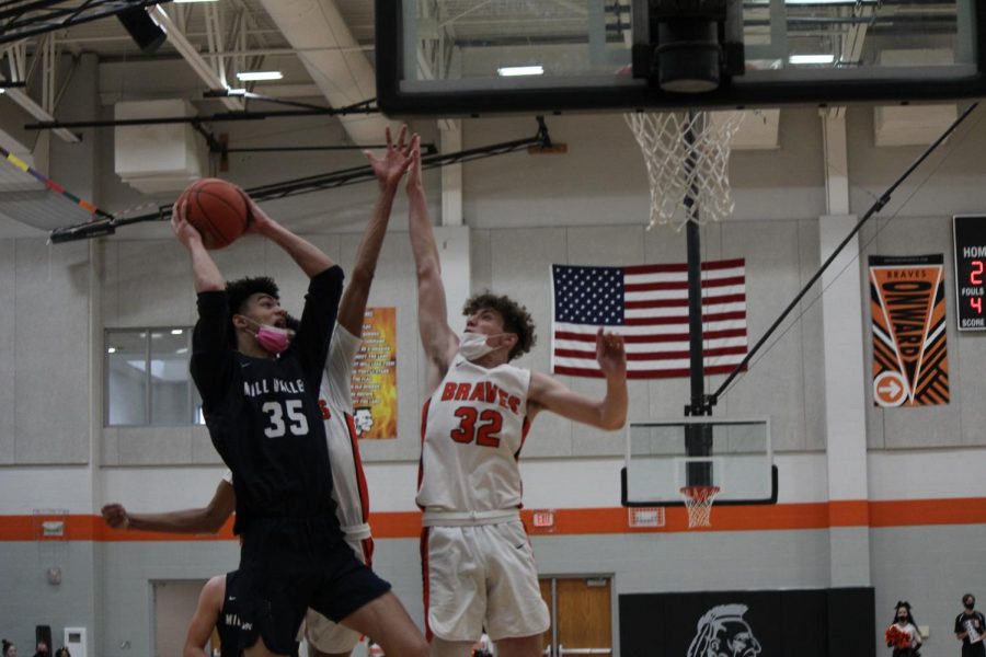 Trying to close in on the goal, junior adrian diamond jumps above his opponents.