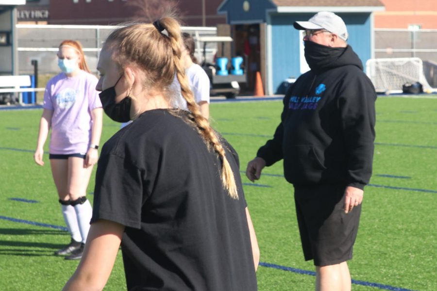 Coach Waldron watches as the players perform a drill to help improve their aim.