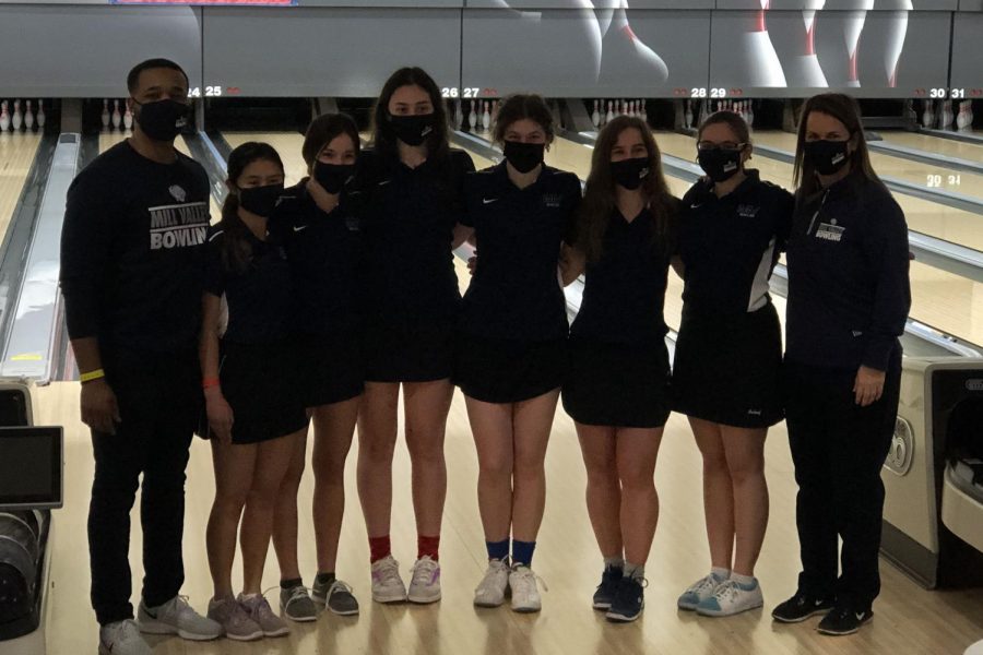 The girls bowling team lines up in front of the lanes for state.