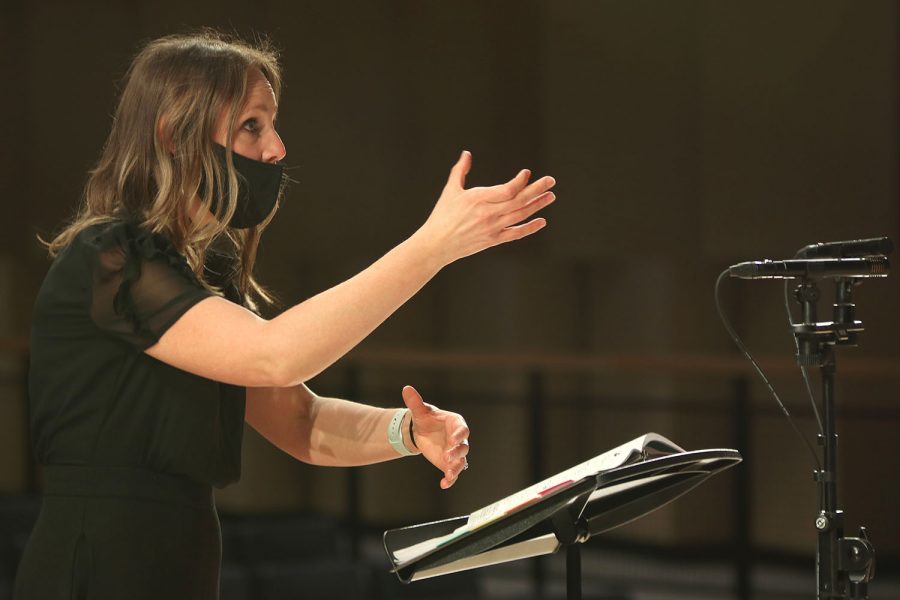 Choir director Jessie Reimer gives instructions to her singers during the concert Tuesday, March 16.