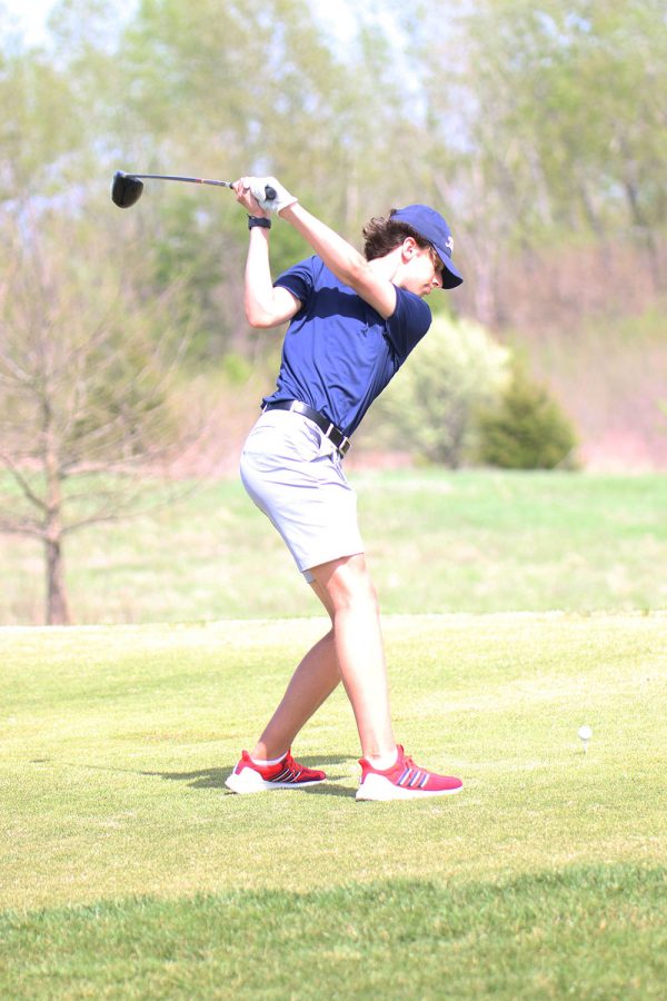 Eyes on the ball, senior Caden Gurwell swings his club. Gurwell went on to score 89 points at the Falcon Lakes Invitational on Monday, April 26.
