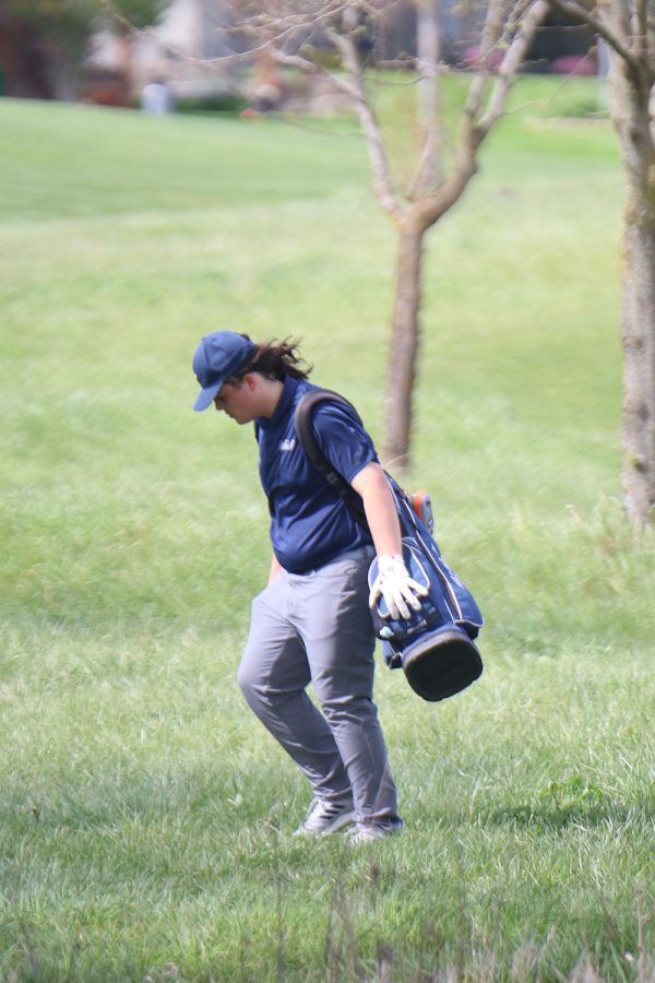 Walking off the course, sophomore Karson Chalupnik looks for his golf ball.
