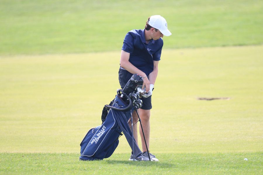 Near his golf ball, junior Jack Weber thinks about what golf club he should select.

