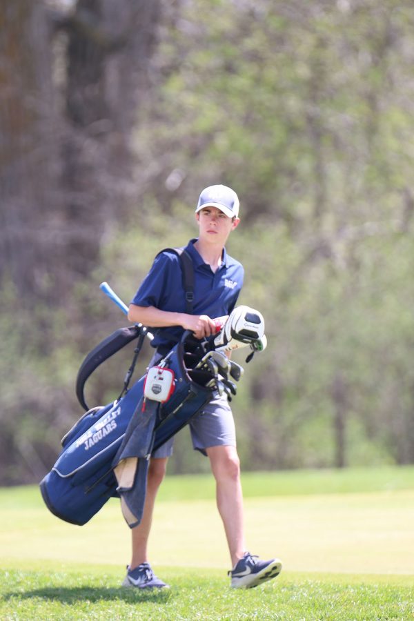 On the move, sophomore Codey Geis walks to the next hole. 
