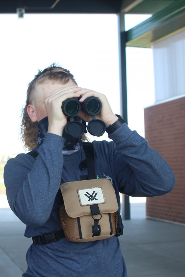 With his binoculars, sophomore Lane Burson tries to get a closer look of the birds. 
