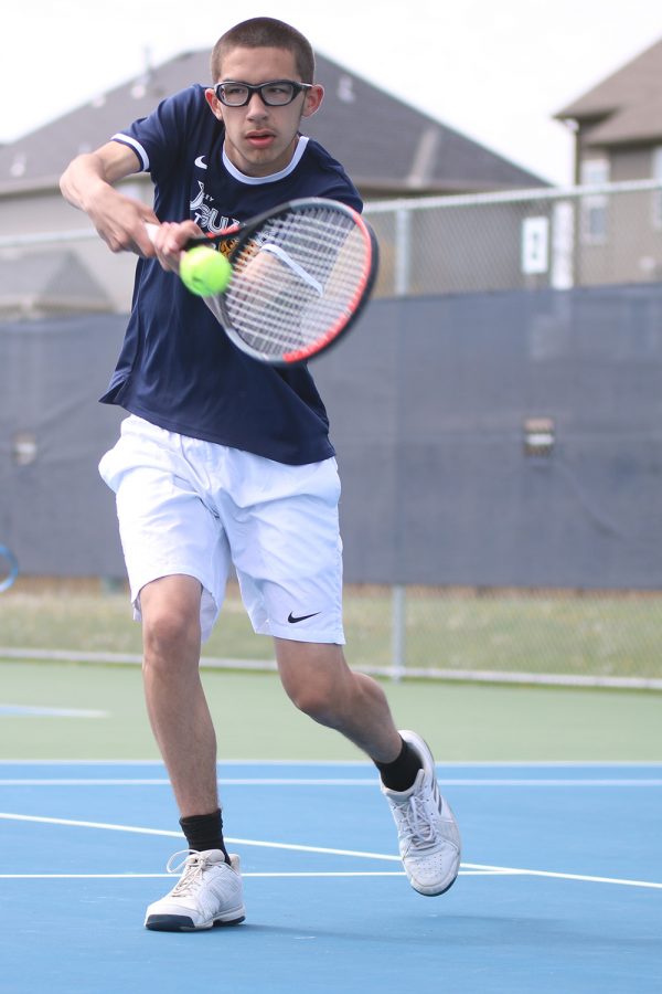 Hitting a backhand, senior Josh Stove focuses on returning the ball across the net.

