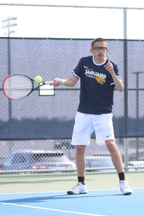 Calling a ball out, senior Jost Stover returns the ball to his opponent. 
