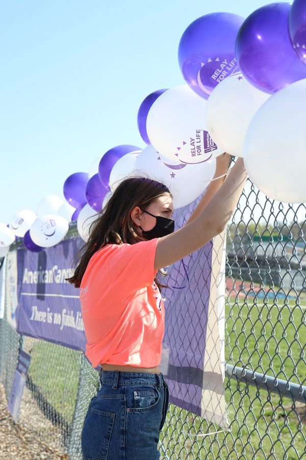 Decorating, senior Claire Burke helps prepare for the event. 
