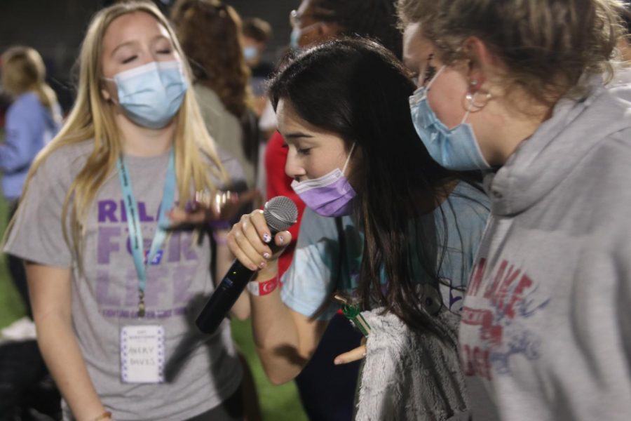 Surrounded by other participants, junior Eden Schanker leads them while singing “Dancing Queen” by ABBA. 