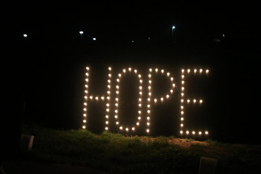The word “Hope” is illuminated in big bright letters near the entrance of the luminaria walk. 