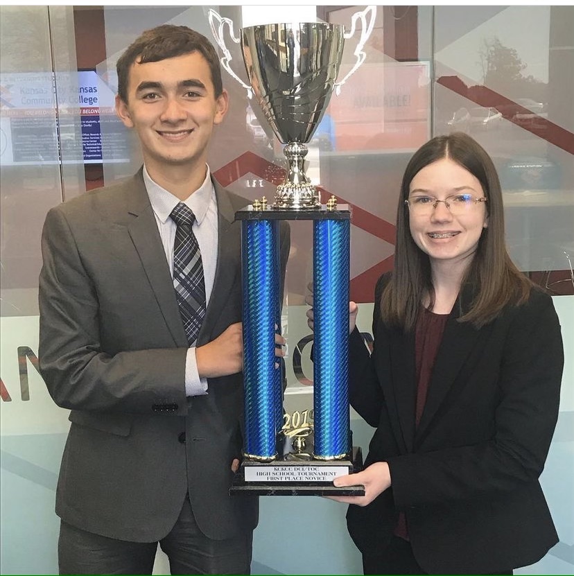 Holding up a trophy from a KCKCC DCI TOC Policy qualifier tournament, sophomores Sarah Johnston and Isaac Steiner smile with their first place novice award Nov. 1 2019. 
