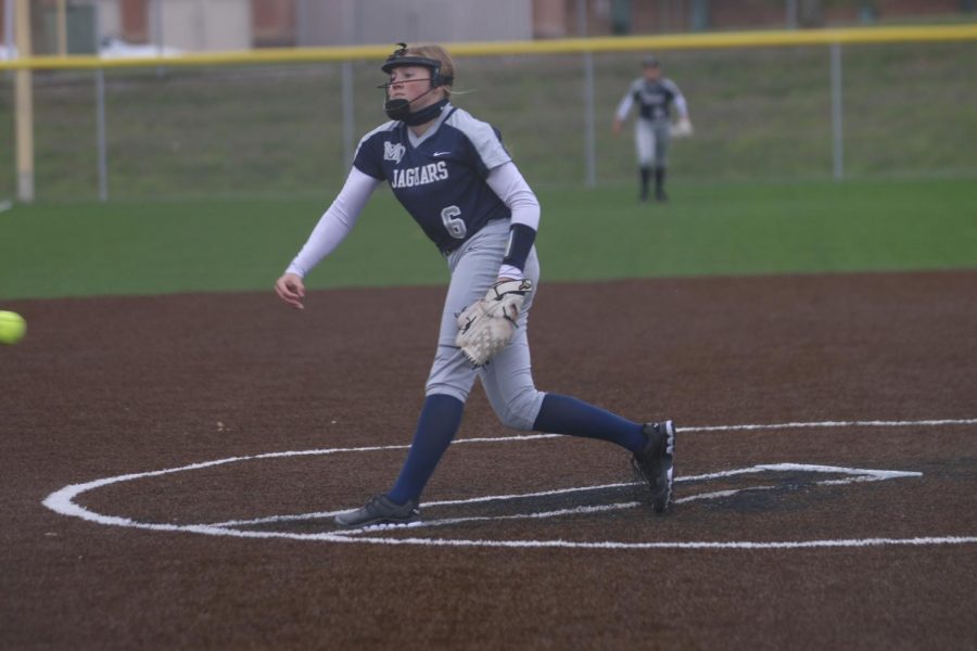 After releasing the ball, sophomore Haley Bryant follows through with her throw.