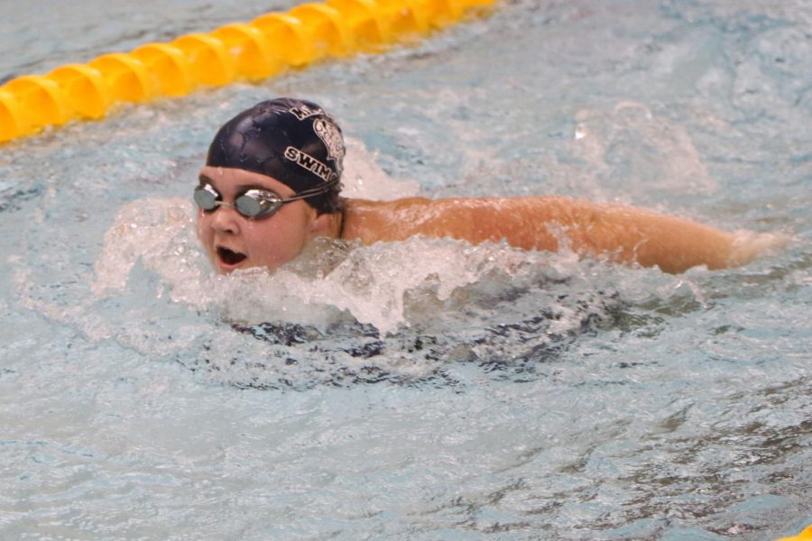 Using her arms to propel herself forward, freshman Kate Haney swims the butterfly.