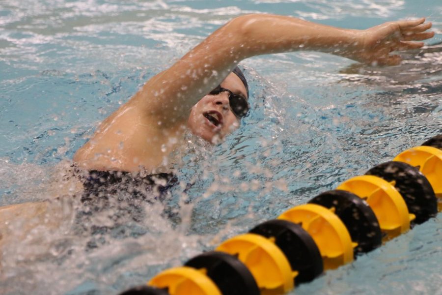 Senior Emma Cross brings her arm up while swimming the freestyle.