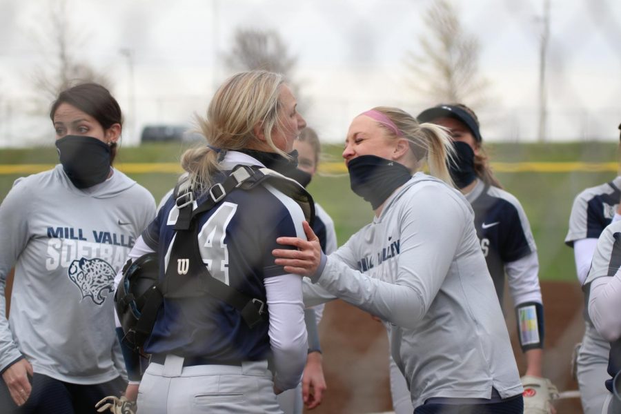 Laughing with coach Jessica DeWild, senior Ava Bredwell smiles in joy along with her teammates. 