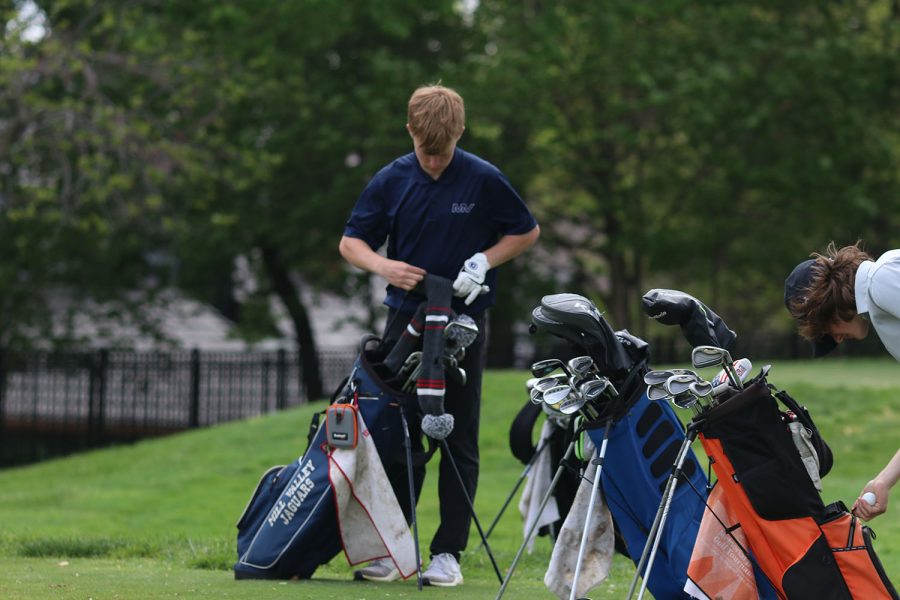 On break, sophomore Matt Morgan covers his golf club while he waits for everyone to hit the ball.