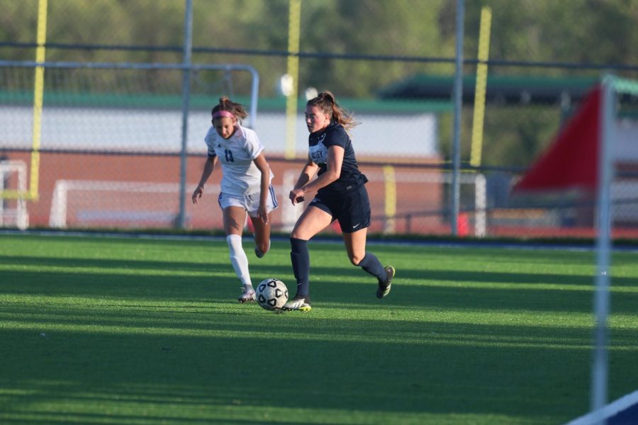 Running with the ball, Senior Katherine Weigel dribbles the ball down the field. The girls team played Olathe Northwest, and the game went into overtime with a final score of 1-1 on Tuesday, May 5. 
