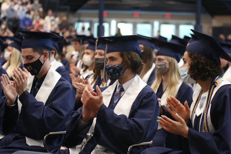 Eyes on the stage, senior Karch Crawford claps as principal Dr. Gail Holder is introduced.