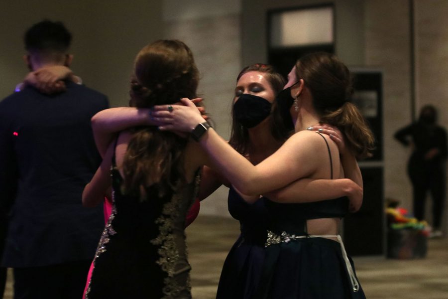 In a circle with her friends, junior Ashley Atkinson sings and dances.