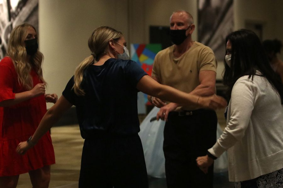 Prom chaperones and teacher Lauren Stringer, Kirsten Crandall and Dorothy Swafford dance in a circle with Principal Dr. Gail Holders husband.