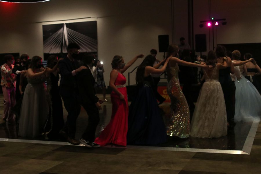 Students wind around the dance floor in a Conga line.