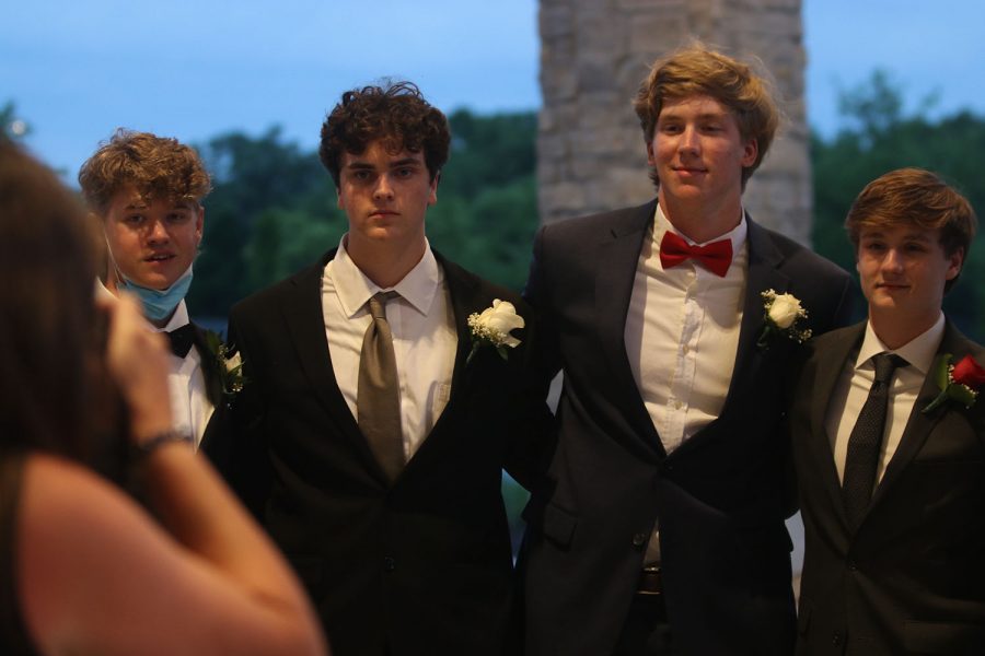 A group of seniors poses for a photo taken by prom sponsor Angie DalBello before entering the venue.