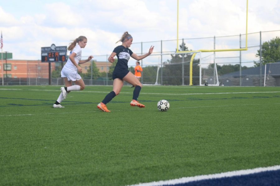 As freshman Kate Ricker goes to shoot for a goal, she makes a move around a defender.