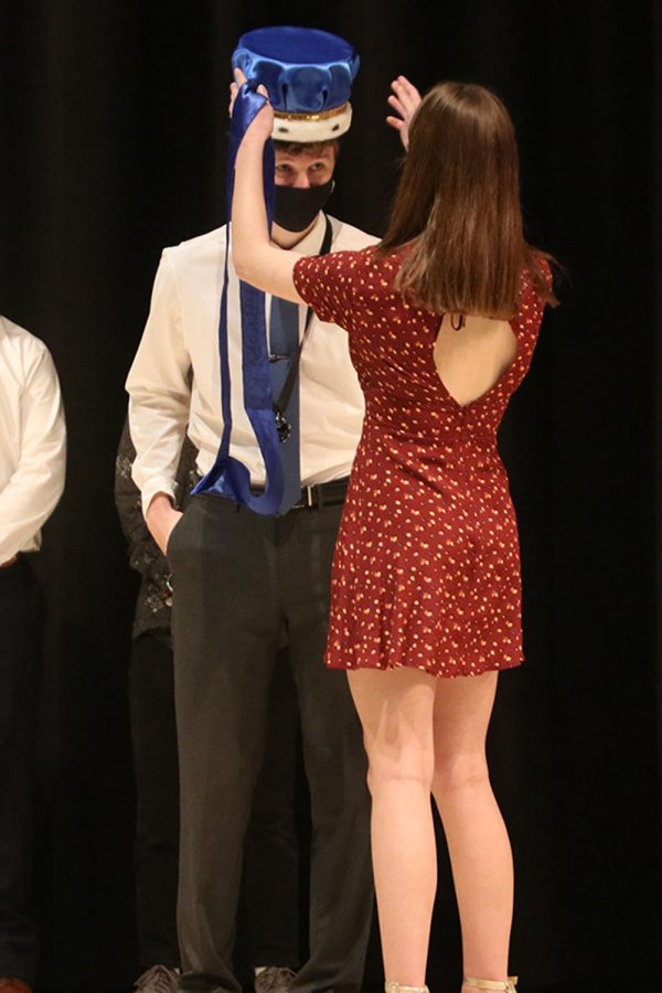 After being announced prom king, senior John Fraka is crowned by student body president senior Ellie Boone.