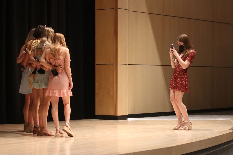 Student body president senior Ellie Boone takes pictures of the prom queen candidates.