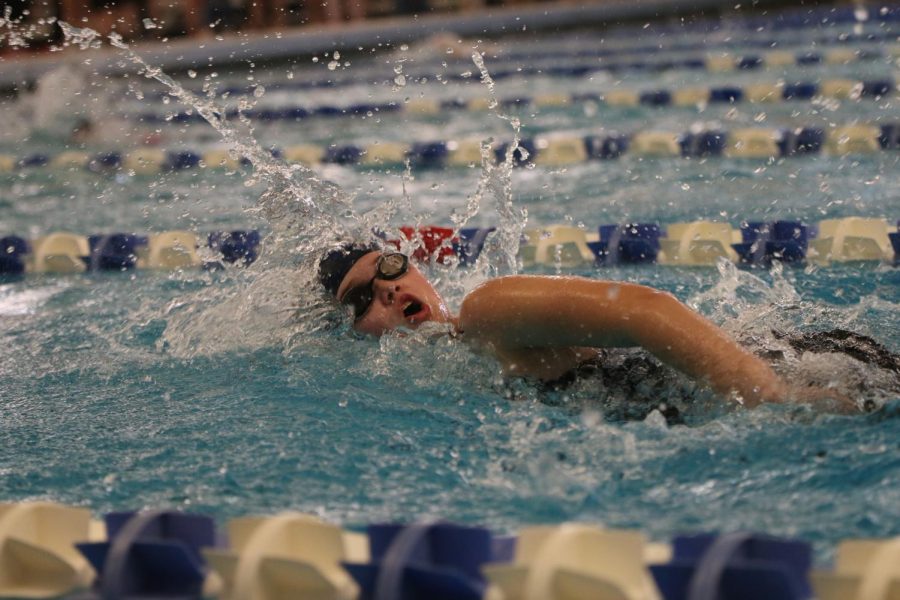 Swimming her leg, senior Emma Cross competes in the 400-yard relay.