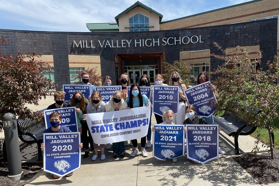 Some members of the 5A state journalism title team celebrate with posters and banners Monday, May 3.