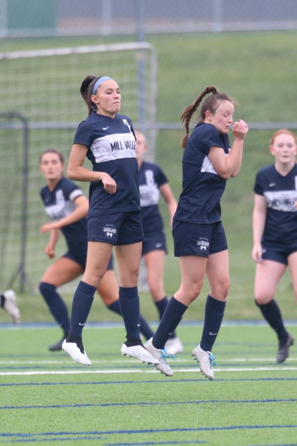 Blocking the ball during a free kick, seniors Katherine Weigel and Hannah Beashore defend the goal.