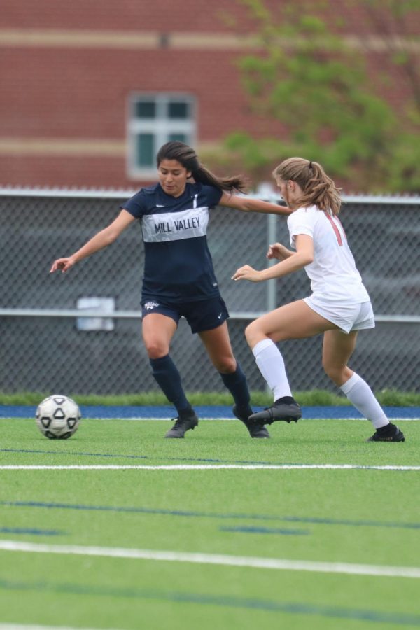 In an effort to defend the ball senior Isabella Loya extends her arm to keep the opponent away from the ball.