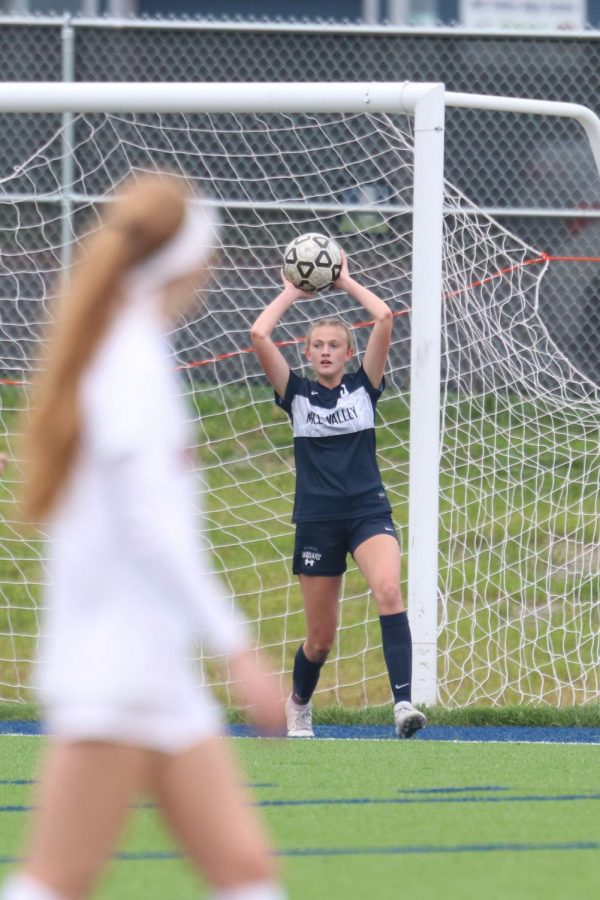 Throwing the ball to a teammate, freshman Julia Coacher gets ready to propel the ball forward.