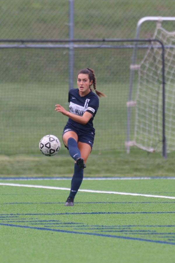 Kicking the ball, sophomore Gracie Knight passes the ball to a teammate. 