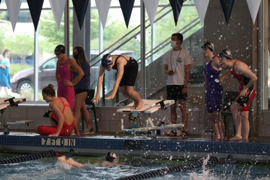 Doing a two-step start, senior Kinley Drummond dives into the pool.