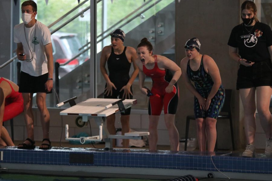 Yelling, senior Cali Rhodes cheers on her relay.