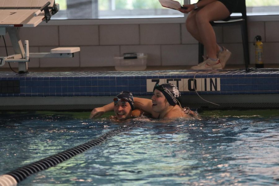 Celebrating after swimming the 100-yard breaststroke, junior Allison Seck hugs sophomore Madison McClure at the Sunflower League Finals Saturday, May 8 