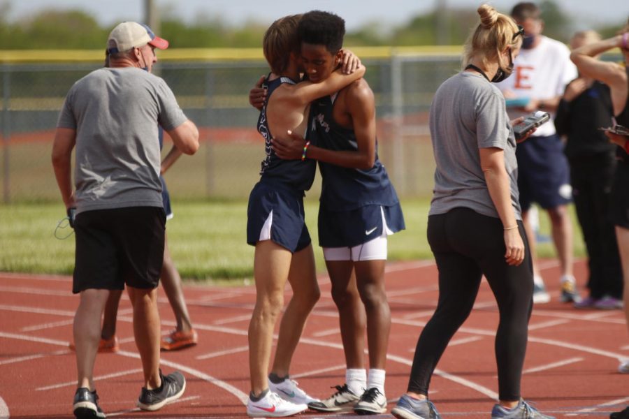 On the track after finishing the 3200m run, freshman AJ Vega and senior Cameron Coad, who placed first and second respectively, share a congratulatory hug. 