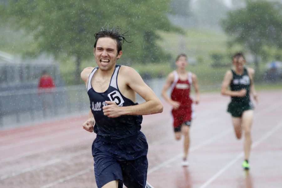 In the torrential downpour, junior Nic Botkin squints through the rain to finish the 1600m race.