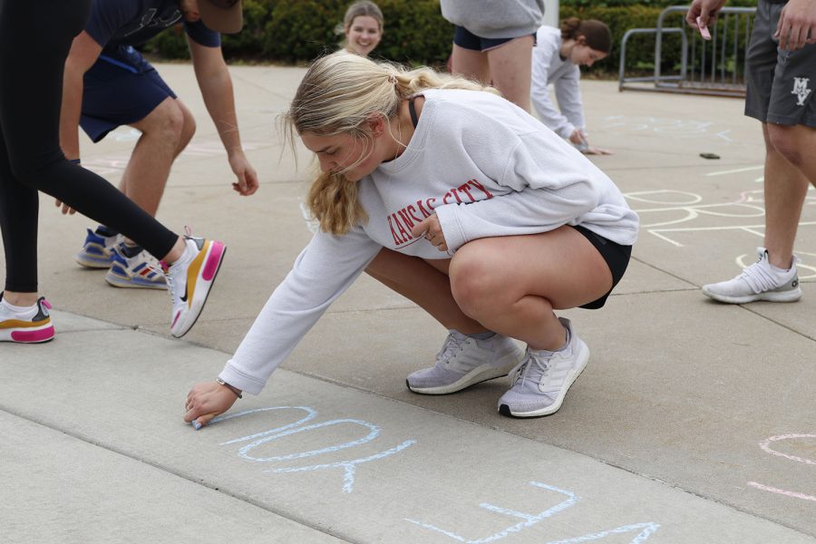 Writing with chalk, NHS member senior Landry Haydock shares a positive message for students.